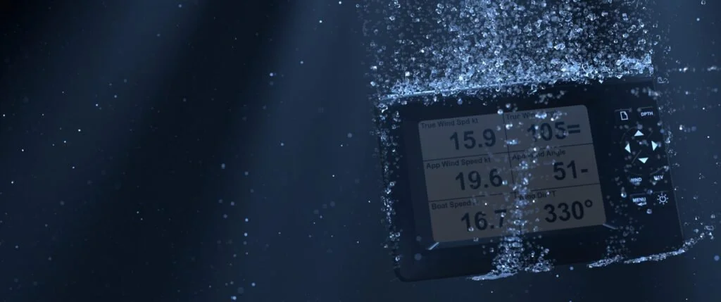 An A+T Instruments digital display showing wind speed and boat speed readings.