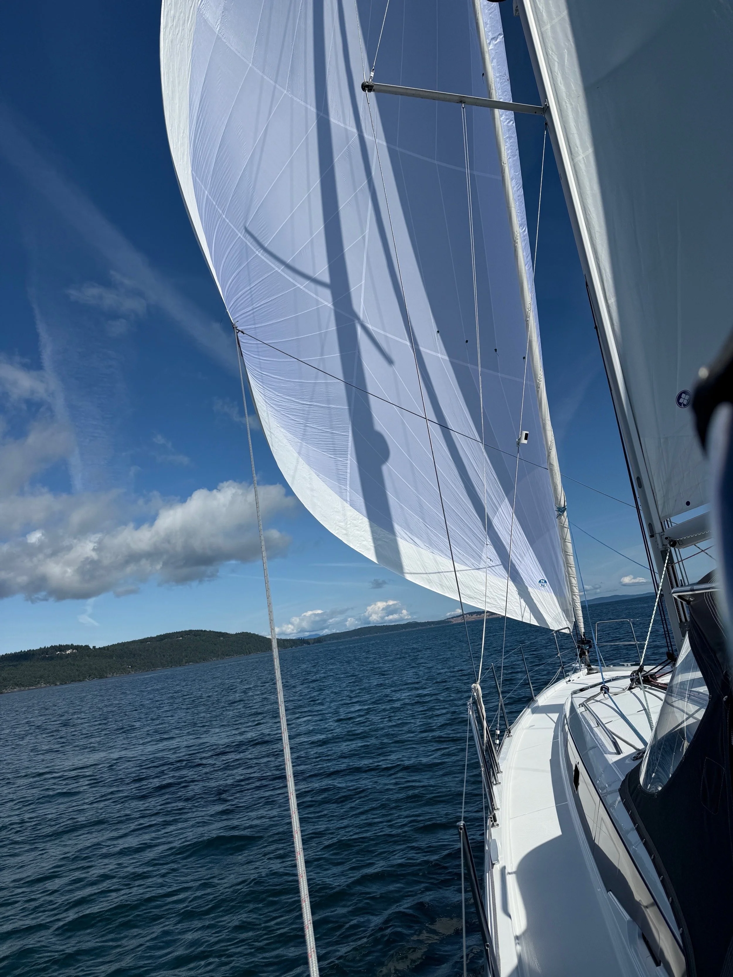 A Jeanneau 410 sailing wing-on-wing with a North Sails Helix headsail.
