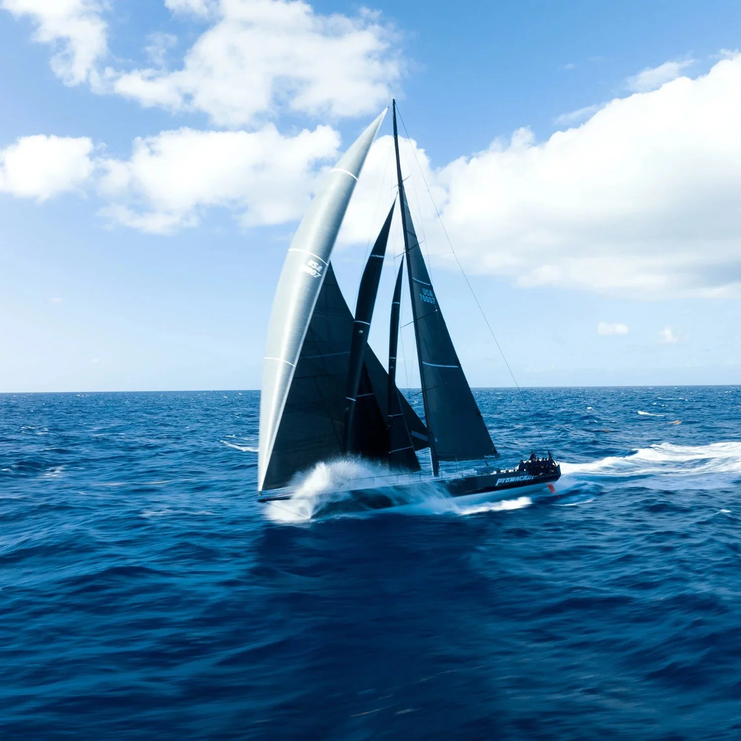 A racing yacht sailing downwind under a North Sails Helix Code Sail.