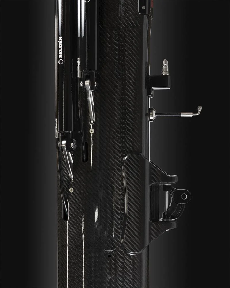 Close-up of a Selden carbon fiber mast, with mounting hardware and cables.